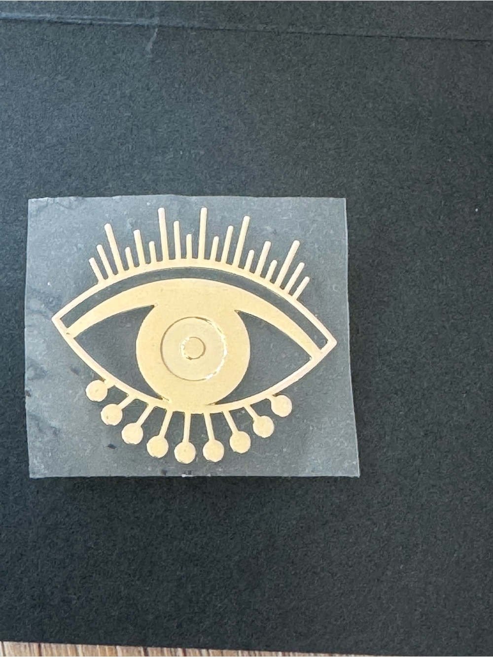 Gold-colored "All-Seeing Eye" lapel pin or brooch